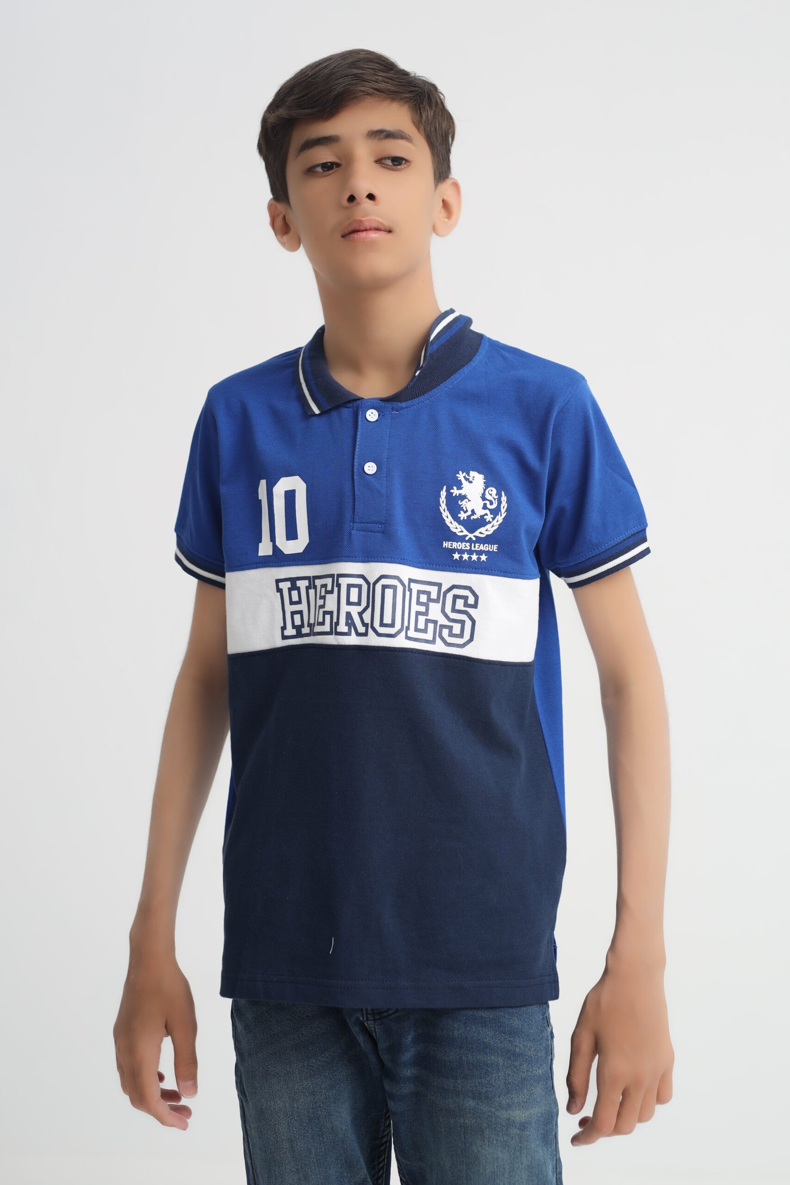 Front view of boys royal blue and navy Heroes League color-block polo shirt