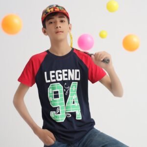 Boy in a navy blue and red Legend 94 cotton T-shirt with badminton racket and colourful balls