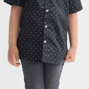 Boy wearing a black and white polka dot half sleeve shirt