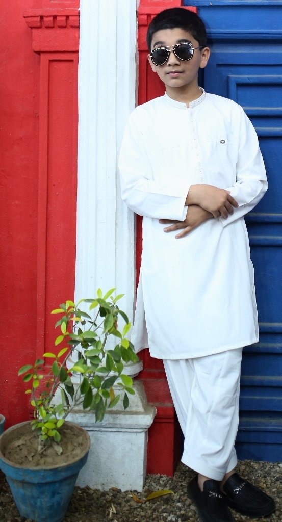 Boy wearing a off-white kurta trouser with black loafers