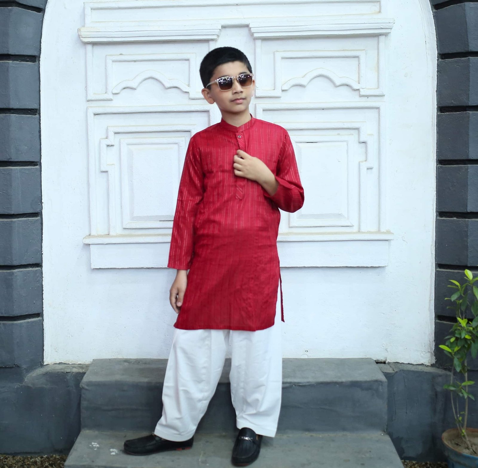 Boy wearing a red cotton blend kurta with full sleeves