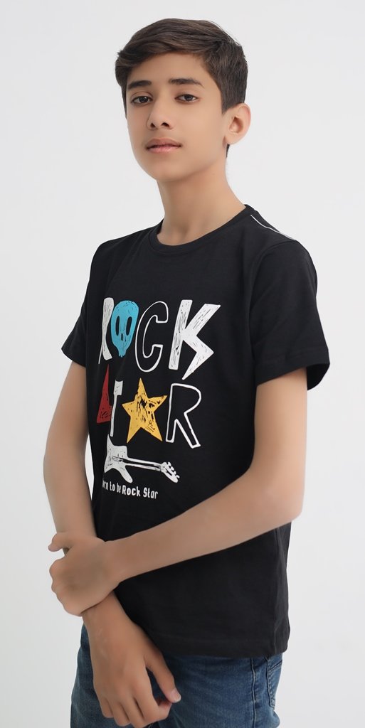 Side view of boy wearing a black Rock Star graphic cotton T-shirt