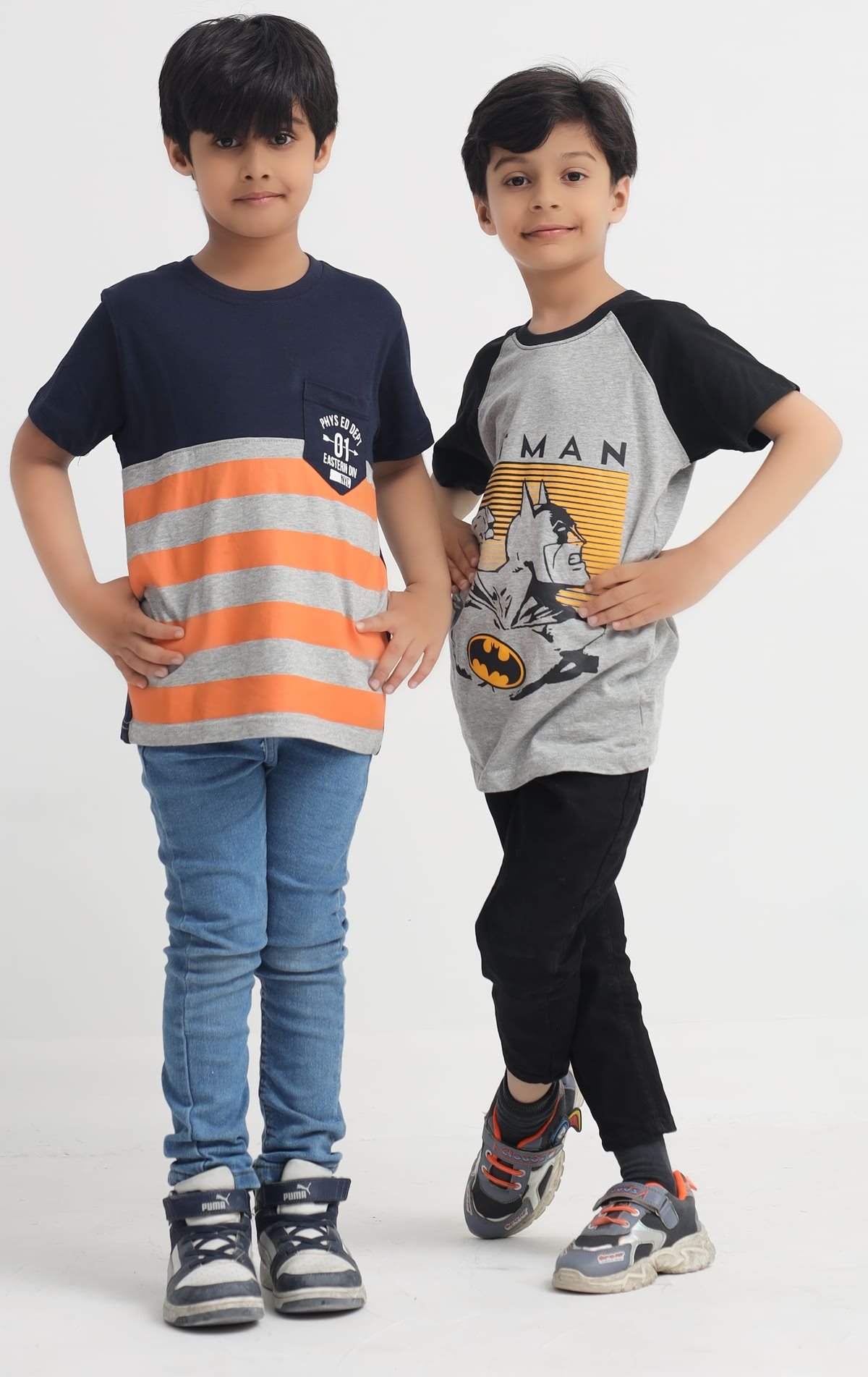 Boy wearing a navy orange and grey striped pocket T-shirt
