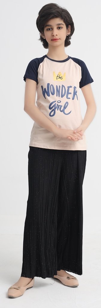 Full view of girl wearing beige graphic T-shirt with navy sleeves