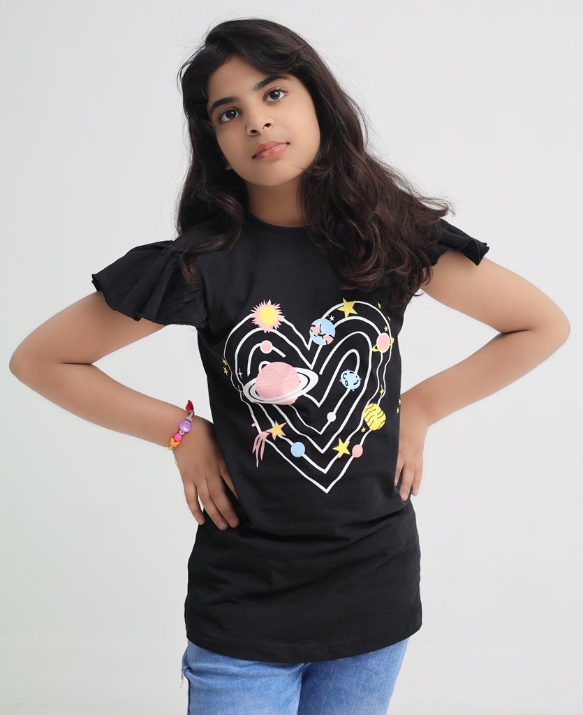 Girl wearing a black space heart graphic cotton T-shirt with ruffle sleeves