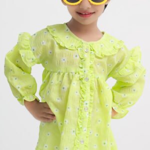Girl wearing a light green floral crinkle frock with ruffle details