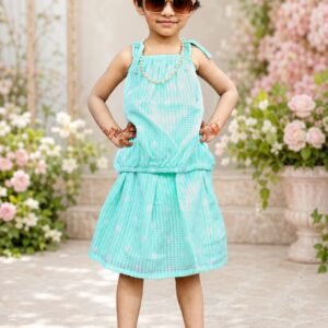 Girl wearing a mint green textured summer outfit with tie shoulders