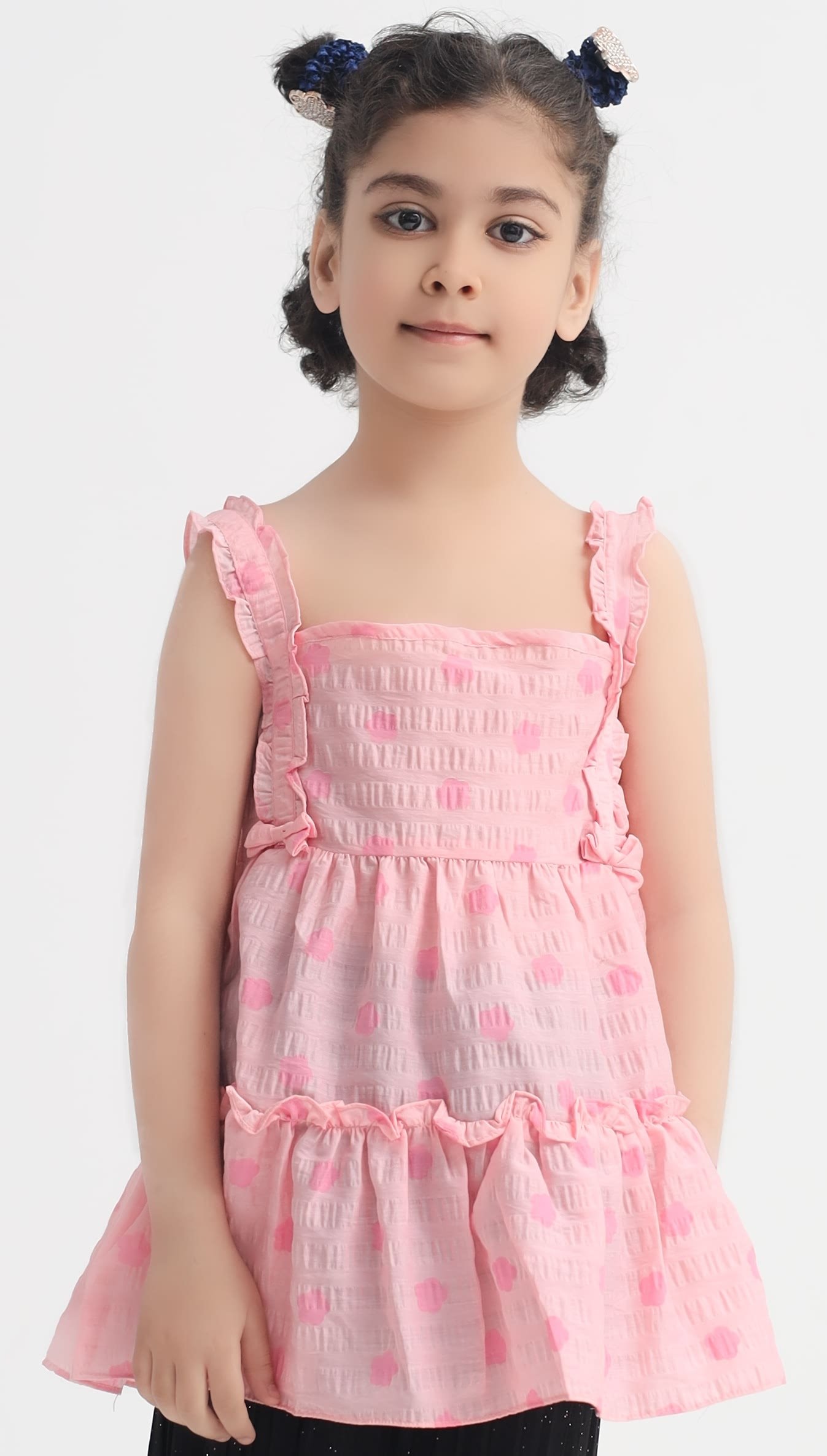 Front view of girls pink textured crinkle frock with ruffle straps