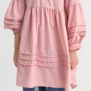 Girl wearing a pink embroidered cotton wash and wear frock