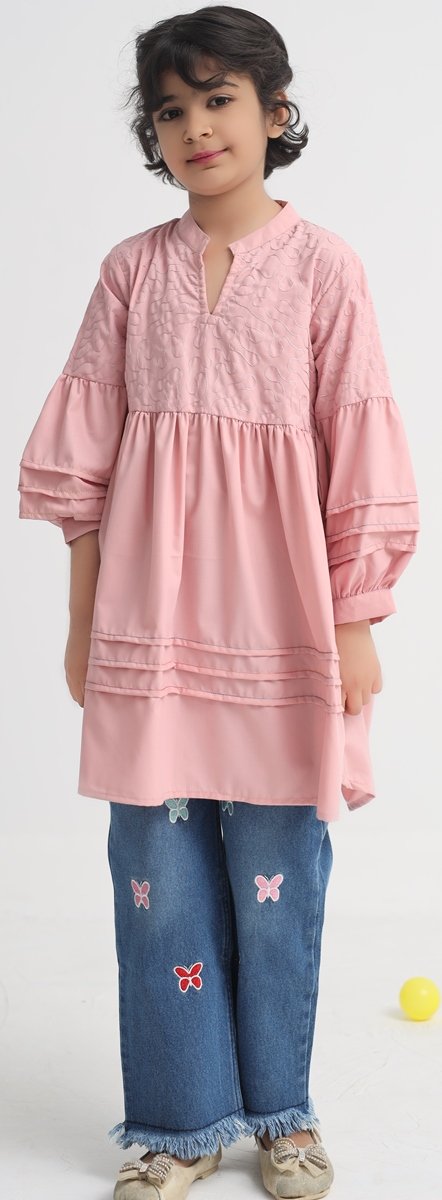 Girl wearing a pink embroidered cotton wash and wear frock