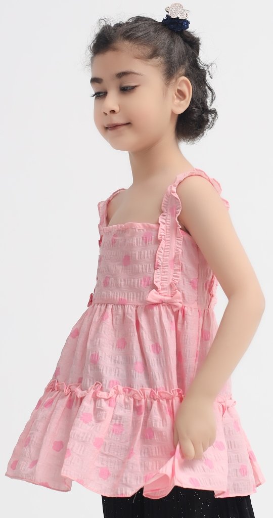 Girl wearing a pink ruffle crinkle summer frock