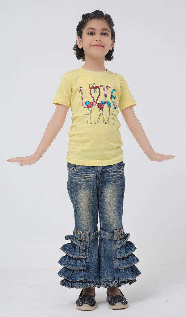Front view of girl wearing a yellow flamingo graphic T-shirt